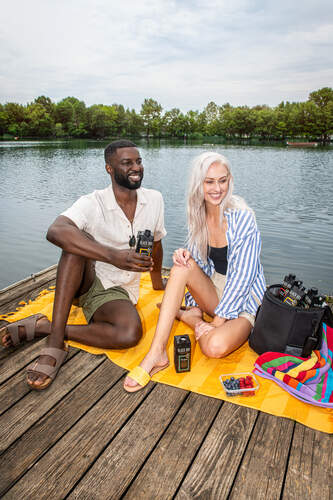 couple enjoying Black Box minis by the lake
