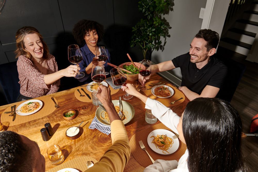 Friends toasting with Black Box and enjoying good food.